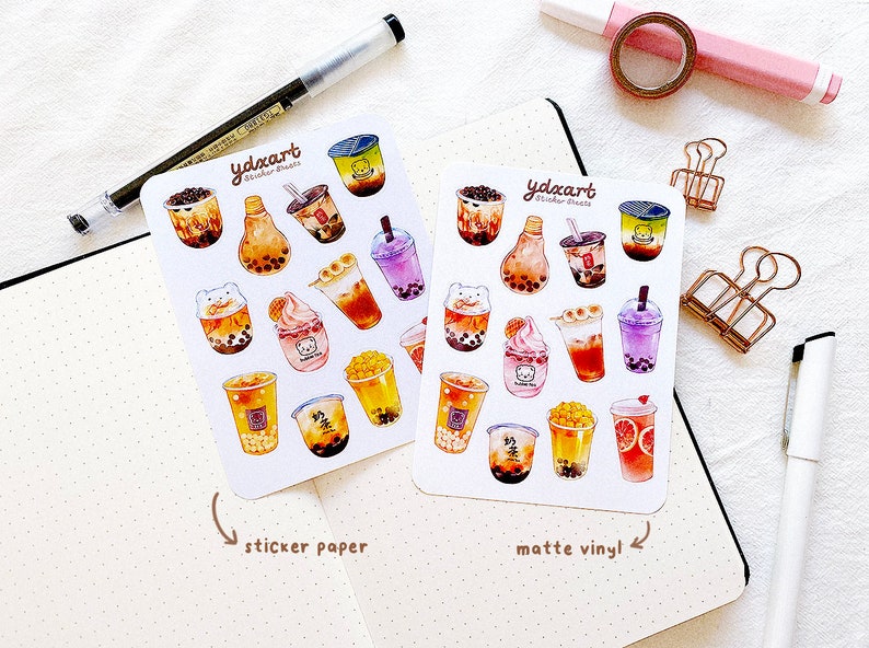 May include: Two sheets of stickers featuring illustrations of bubble tea drinks. The stickers are labeled "ydxart sticker sheets" and are available in both sticker paper and matte vinyl.