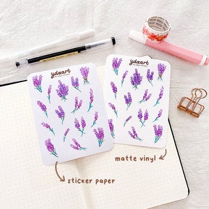 May include: Two sheets of lavender flower stickers. One sheet is labeled "sticker paper" and the other is labeled "matte vinyl".