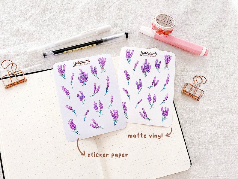 May include: Two sheets of lavender flower stickers. One sheet is labeled "sticker paper" and the other is labeled "matte vinyl".