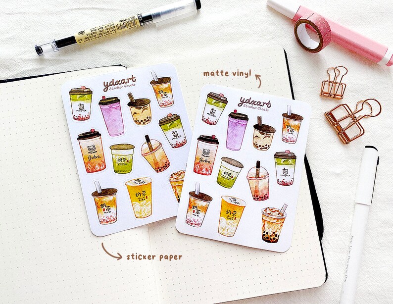 May include: Two sheets of stickers featuring watercolor illustrations of bubble tea cups. The stickers are on white paper with the text "ydxart sticker sheets" and "matte vinyl!" printed on them.