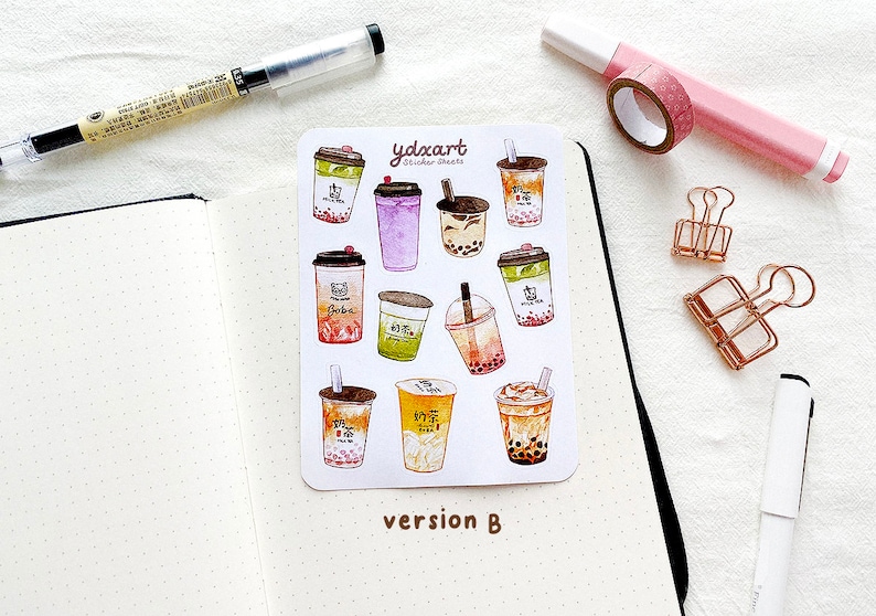 May include: A sheet of stickers featuring various illustrated bubble tea cups with different flavors and toppings. The stickers are on a white background and have the text "ydxart Sticker Sheets" and "version B" printed on them.