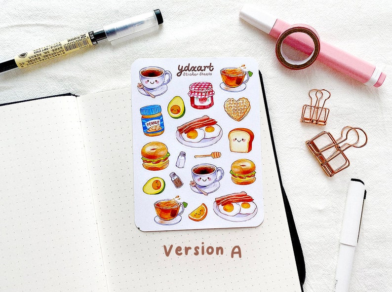 May include: A sheet of stickers featuring a variety of breakfast foods, including coffee, eggs, bacon, toast, bagels, and avocado. The stickers are on a white background with the text "ydxart sticker sheets" in the top center.