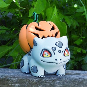 Calabaza espeluznante de Halloween Pumpkasaur - Portavelas LED con forma de calabaza de Halloween