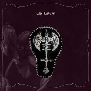 May include: A silver and black pin with an axe design, set against a black background with a decorative border. The pin is shaped like an axe and has intricate patterns. The text "The Labrys" is at the top.