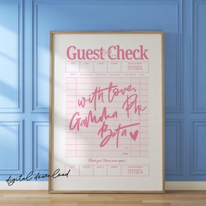 May include: A framed print featuring a pink "Guest Check" design with the text "with love, Gamma Phi Beta" and a heart symbol. The print has a grid layout with spaces for details and a check number. The words "digital download" are at the bottom.