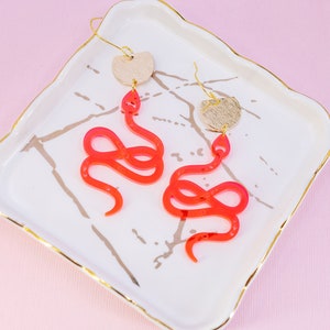 Fluorescent Snake Earrings with Gold Accents", "Fun and Quirky Earrings", "Summer Novelty Earrings
