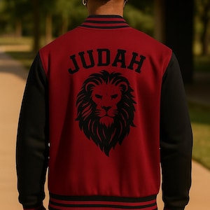 May include: A burgundy and black letterman jacket with the word "JUDAH" arched across the back in black block letters. Below the text is a black lion's head graphic. The jacket has black sleeves and striped trim.