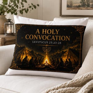May include: A decorative pillow with a black background and gold text that reads "A HOLY CONVOCATION" and "LEVITICUS 23:23-25". The image depicts a gathering around a fire with tents in the background.