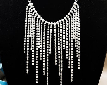 Showers by JJD is a beautiful shower of strand rhinestones on a silver-plated chain. The earrings are an elegant pair of nickel-free hooks.