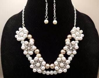 Ivanna is a beautiful faux pearl and rhinestone necklace set with a single faux pearl drop earrings on a silver-plated chain. Great gift.