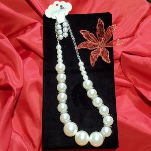 Pearls- Just Jewels Designs &quot;Adjustable&quot; is a large to small cream-colored faux pearls necklace set with silver-plated spacers.