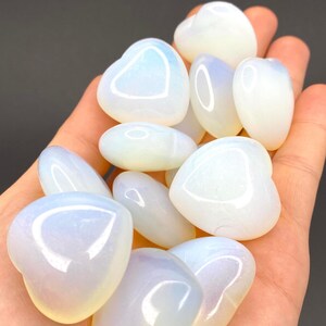 A collection of heart shaped blue and white opalite stones