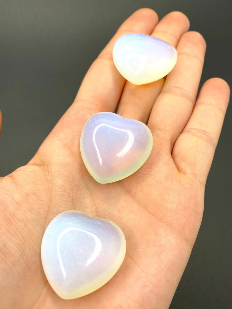 Three heart shaped blue and white opalite stones