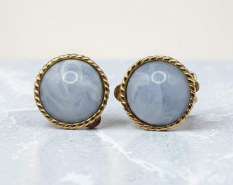 Gold tone light blue white swirl cabochon .75 inch clip on earrings ear clips