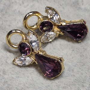 May include: A white ceramic mug with a black handle and the text "But First, Coffee" in a black, handwritten-style font. The mug is on a white surface.