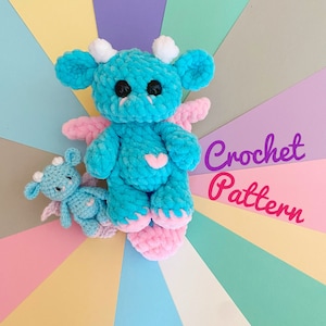 May include: A crochet pattern for a blue and pink dragon amigurumi toy. The dragon has a heart on its chest and is sitting on a colorful background. Crochet Pattern.