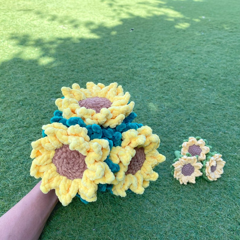 May include: A bouquet of crocheted sunflowers in yellow and green. The sunflowers are arranged in a cluster and have a fuzzy texture.