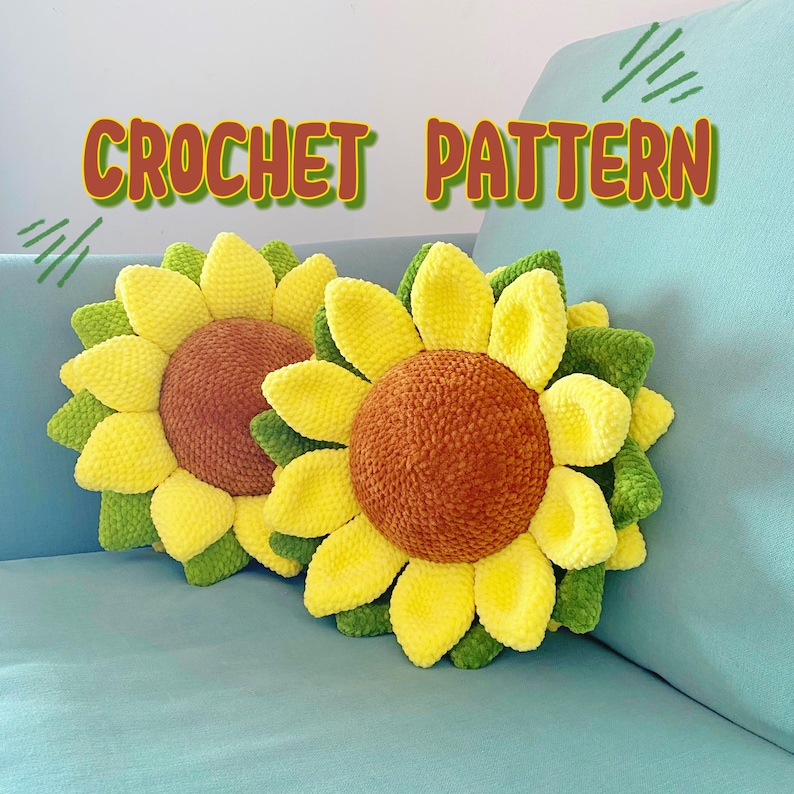 May include: Two crochet sunflower pillows with yellow petals, green leaves, and brown centers rest on a light blue surface. The text "CROCHET PATTERN" is displayed above the pillows in orange and green.