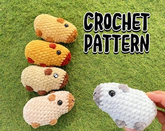 May include: A collection of handmade crochet guinea pigs in various colors, including tan, yellow, and light gray. The text "CROCHET PATTERN" is displayed in a bold, black font. The guinea pigs have small black eyes and brown or gray accents.