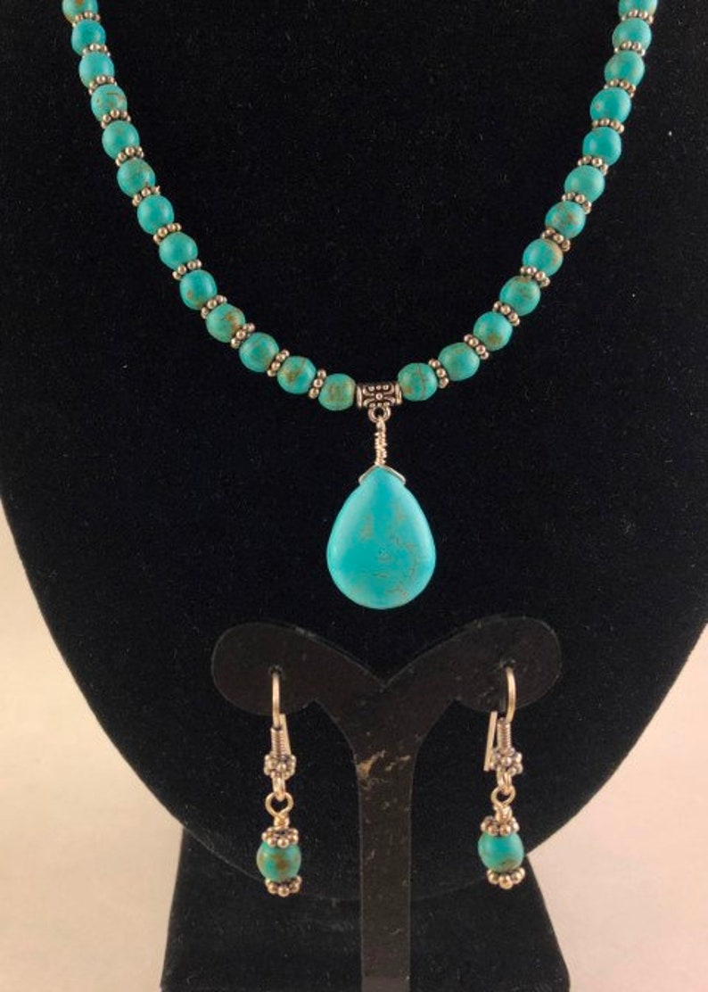 Blue Turquoise Pendant Wire Wrapped to a Necklace of Turquoise Beads Separated by Silver Daisy Spacers with Matching Earrings