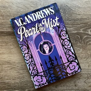 May include: A book cover with a purple and black design. The title is "Pearl in the Mist" by V.C. Andrews. The cover features a woman looking out of a window.