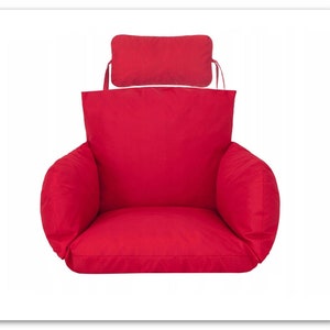 May include: Red chair cushion with a matching red back cushion. The cushion has a thick, padded seat and armrests.