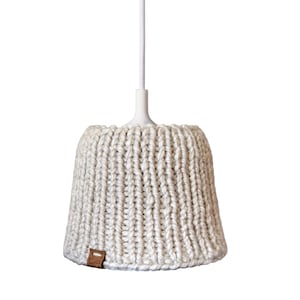 May include: A white pendant light with a beige knitted shade. The shade has a textured, crocheted design.