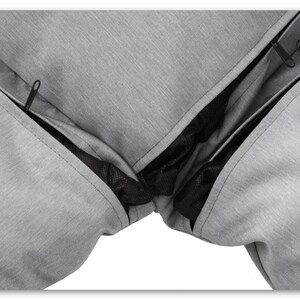 May include: Close-up of a grey zipped cushion cover with a black mesh lining. The zipper is open, revealing the lining.