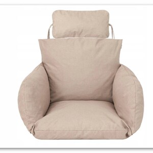 May include: Beige swing chair cushion with a matching headrest. The cushion has a thick, padded seat and back, and the headrest is attached to the back of the cushion with ties.