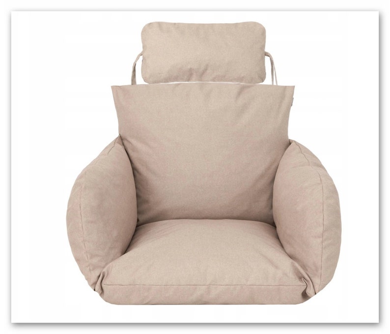 May include: Beige swing chair cushion with a matching headrest. The cushion has a thick, padded seat and back, and the headrest is attached to the back of the cushion with ties.