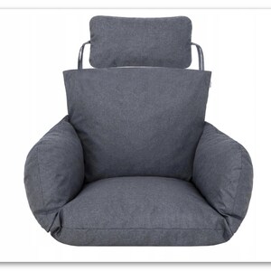 May include: Grey chair cushion with a matching headrest. The cushion has a thick, padded seat and back, and the headrest is attached to the back of the cushion with two straps.