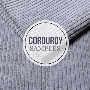 May include: Close-up of gray corduroy fabric samples. The fabric has a ribbed texture with vertical lines. The words "CORDUROY SAMPLES" are displayed in a circular graphic. The fabric is folded over, showing the texture and color variations.