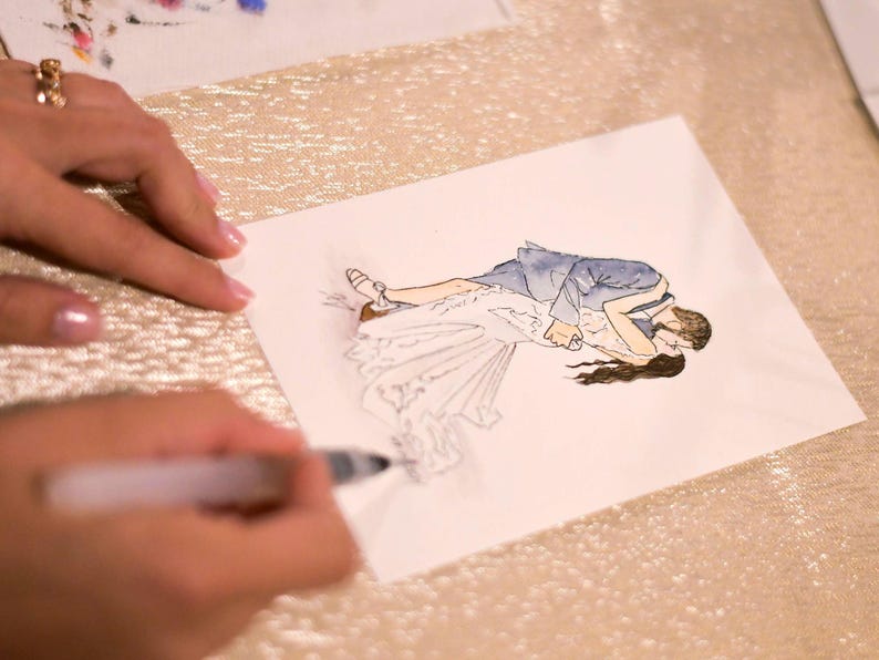 May include: A watercolor illustration of a couple embracing. The woman is wearing a white dress and the man is wearing a blue suit. The illustration is on a white card.