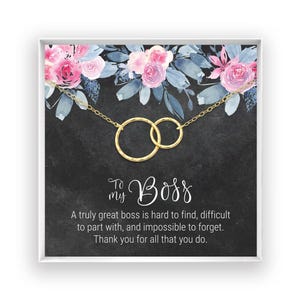 The image is a framed print with a floral design and a gold chain necklace. The text on the print reads: "To my Boss, A truly great boss is hard to find, difficult to part with, and impossible to forget. Thank you for all that you do."