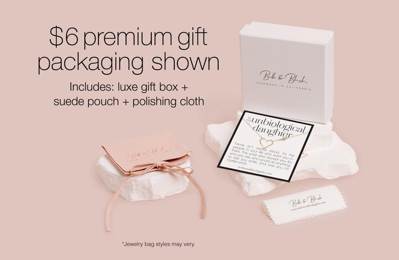 The image is an advertisement for a premium gift packaging service. It features a white box with a gold label, a pink gift bag, and a white cloth. The text on the image provides details about the premium gift packaging, including a luxury gift box, a suede pouch, and a polishing cloth. The image also includes a note about jewelry bag styles and a caution about avoiding redundancy and vague wording.