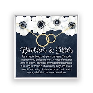 The image is a framed print with a black background and white flowers. The text on the print reads "Brother & Sister" and provides a heartfelt message about the special bond between siblings, expressing trust, love, and the importance of sharing and caring for one another.
