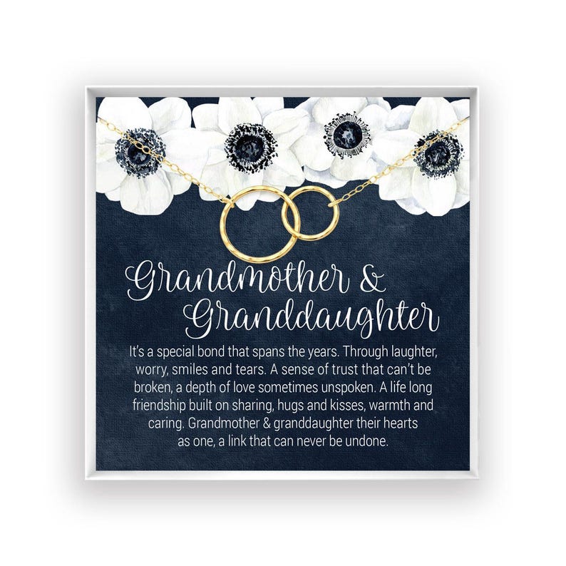 a black and white card with white flowers on it