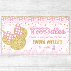 May include: Pink and gold birthday banner with a Minnie Mouse head, polka dots, and stars. The text reads "Oh Two-dles It's hard to believe, but yes, it's true, our Emma Miller is turning 2."