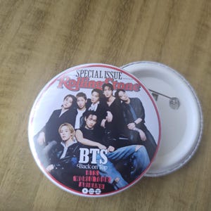 May include: A circular pinback button featuring a Rolling Stone magazine cover graphic with the group BTS. The text reads SPECIAL ISSUE, Rolling Stone, BTS, Back on Top, and BTS WORLD TOUR ARIRANG. The pin has a white plastic back with a metal pin.