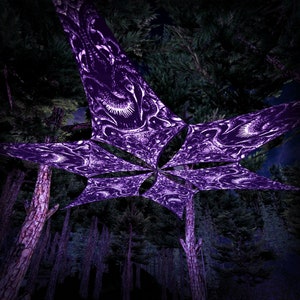 May include: A low-angle view of a forest canopy with a large, star-shaped structure. The structure is a deep purple color with intricate white patterns. The forest is filled with tall, dark green trees.