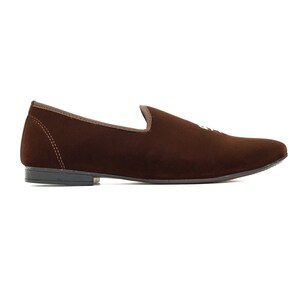 May include: Brown velvet loafers with a pointed toe and a simple design.