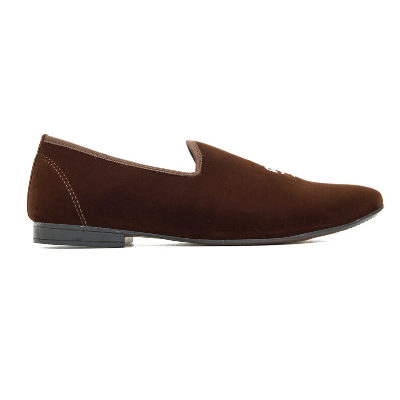 May include: Brown velvet loafers with a pointed toe and a simple design.