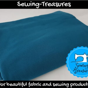 May include: A teal blue fabric swatch, folded in half, with a white background. The fabric is smooth and has a slight sheen. The image includes the text "Sewing-Treasures for beautiful fabric and sewing products".