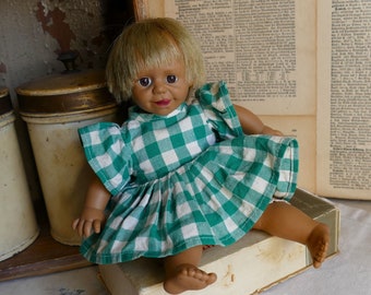 Older little doll with checkered dress, rogue, collector, toy, decoration, nostalgia