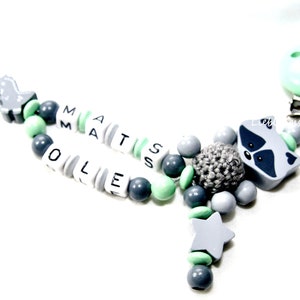 Schnullerkette Doppelname Waschbär mit Dino