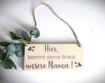 Wooden sign announcing, here comes your bride nature