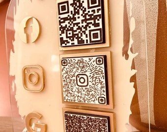 May include: A gold-colored acrylic sign with the text "connect with me" in gold lettering. The sign has three QR codes and social media icons for Facebook, Instagram, and Google.