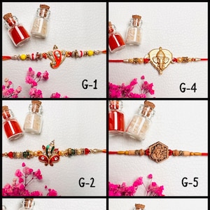 May include: A collection of six Rakhi bracelets with intricate designs. Each bracelet features a central charm, such as a deity or floral motif, and is adorned with beads. The bracelets are displayed with small glass bottles and pink flowers.