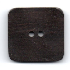 May include: A dark brown square button with two holes in the center.