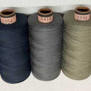 May include: Five spools of thread in different colours. The spools are labelled with the numbers 1254, 0954, 0416, 1239, and 0381.